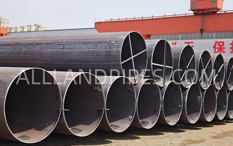 High-strength LSAW steel pipes stored in production yard, suitable for API 5L X42 to X80 pipeline projects