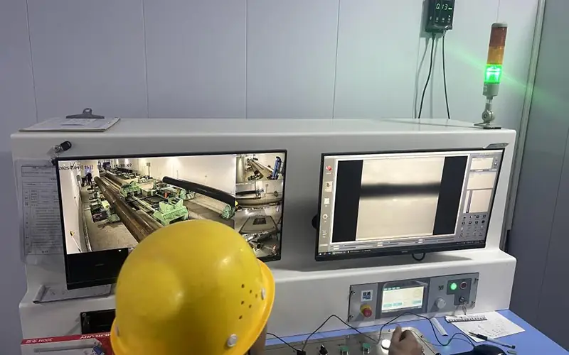 A quality control technician analyzing the X-ray radiograph of a steel pipe's weld seam on a high-resolution screen to ensure it meets quality standards.-banner