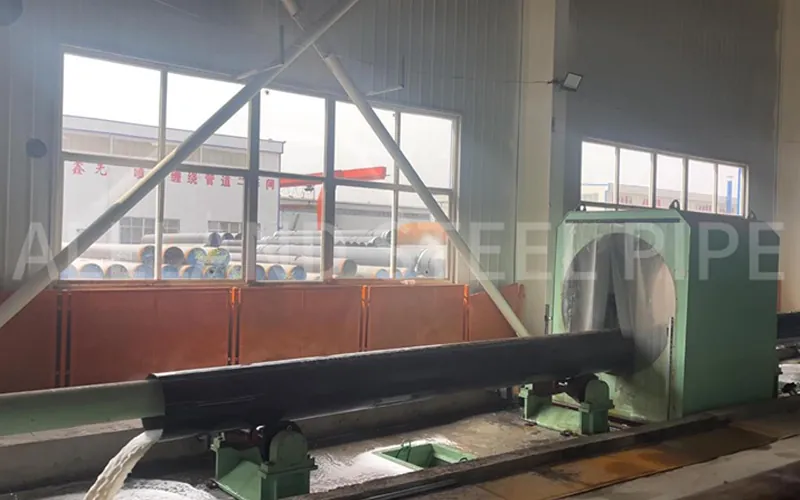 The hydrostatic testing of a large-diameter steel pipe in a factory test bay, where it is filled with water and pressurized to API 5L standards to verify its strength and integrity-banner