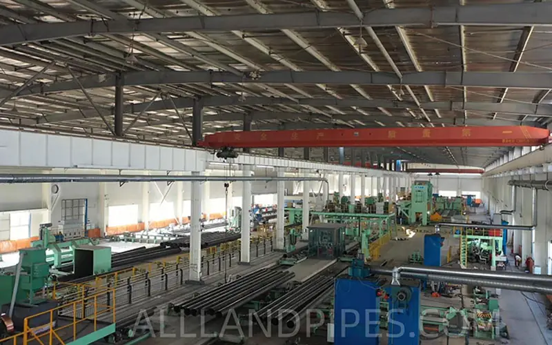 The interior of a large, organized LSAW steel pipe manufacturer's factory, showing the complete production line and equipment.-banner