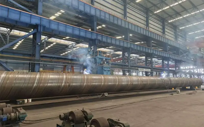 Manufacturing of large diameter SSAW (spiral submerged arc welded) steel pipe conforming to DIN 2458 dimensions in the factory.-banner