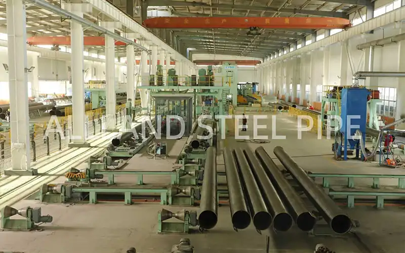 Interior view of Allland Steel Pipe's modern JCOE manufacturing facility in China, featuring large diameter LSAW pipe production lines.-banner