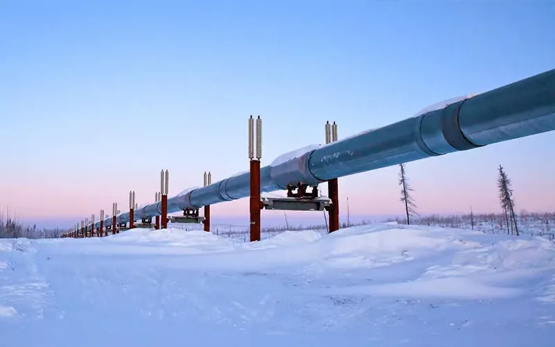 Large diameter API 5L line pipe system transporting oil across snowy terrain, demonstrating high resilience in extreme cold environments-banner