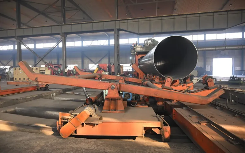 SSAW pipe (spiral submerged arc welded steel pipe) on the production line in an industrial factory-banner