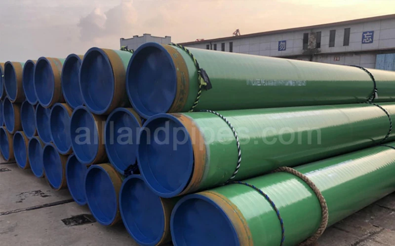 Custom green 3LPP coated steel pipeline pipe stored at manufacturer yard for high-temperature subsea and industrial piping banner