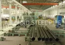Interior view of Allland Steel Pipe's modern JCOE manufacturing facility in China, featuring large diameter LSAW pipe production lines.-banner