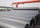 A stockyard of large-diameter black LSAW and SSAW pipes, showing the raw material for a buyer's pros and cons analysis.-banner