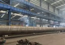 Manufacturing of large diameter SSAW (spiral submerged arc welded) steel pipe conforming to DIN 2458 dimensions in the factory.-banner