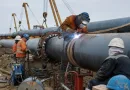Field welding of large diameter ERW and LSAW steel pipes during pipeline construction on coated carbon steel pipe banner