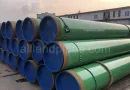 Custom green 3LPP coated steel pipeline pipe stored at manufacturer yard for high-temperature subsea and industrial piping banner