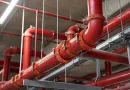 Large-diameter fire sprinkler pipes connected with grooved couplings in a commercial building installation banner