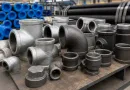 Malleable iron pipe fittings in industrial warehouse for BS EN and ASTM threaded steel pipe systems banner