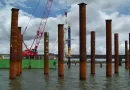Installation of large-diameter SSAW steel pipe piles for marine bridge foundation, showing visible spiral weld seams.-banner