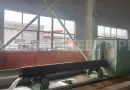 The hydrostatic testing of a large-diameter steel pipe in a factory test bay, where it is filled with water and pressurized to API 5L standards to verify its strength and integrity-banner